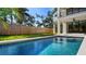 Inviting backyard pool with modern tiled trim and spacious fenced in yard perfect for outdoor relaxation and entertainment at 2249 Oak Terrace Ter, Sarasota, FL 34231