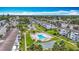 A beautiful aerial view showcases the community pool, shuffleboard, and manicured lawns in this well-maintained complex at 2321 Canal Dr # F25, Bradenton, FL 34207