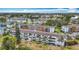 Panoramic aerial view of a condo complex offering a pool, parking, and lush landscaping at 2321 Canal Dr # F25, Bradenton, FL 34207