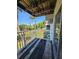 Cozy balcony with wood floors showcasing an open outdoor green space with trees at 2321 Canal Dr # F25, Bradenton, FL 34207