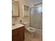 Bright bathroom features a white vanity and shower with glass door at 2321 Canal Dr # F25, Bradenton, FL 34207