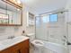 Bathroom featuring vanity with mirror, toilet, and shower-tub combo with sliding glass door at 2321 Canal Dr # F25, Bradenton, FL 34207