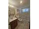 Bright bathroom features a white vanity and shower with glass door at 2321 Canal Dr # F25, Bradenton, FL 34207