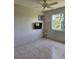 The bedroom is bright with tile floors, ceiling fan, tv, and a window at 2321 Canal Dr # F25, Bradenton, FL 34207