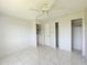 This bedroom features a ceiling fan and tile flooring, with closets for storage at 2321 Canal Dr # F25, Bradenton, FL 34207