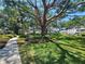 Scenic walkway through a lush community area with mature trees and manicured landscaping at 2321 Canal Dr # F25, Bradenton, FL 34207