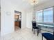 Bright dining area with tile flooring, adjacent to the kitchen, complemented by natural light from the window at 2321 Canal Dr # F25, Bradenton, FL 34207