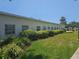 Exterior of condo building showcasing manicured hedges and lush green lawn on a sunny day at 2321 Canal Dr # F25, Bradenton, FL 34207