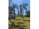 Condo complex with well-maintained lawn and palm trees showing building facade and balconies at 2321 Canal Dr # F25, Bradenton, FL 34207