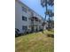Condo exterior with balconies and white painted siding, complemented by palm trees at 2321 Canal Dr # F25, Bradenton, FL 34207