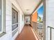 Exterior hallway to units with white walls, and pops of orange color on a sunny day at 2321 Canal Dr # F25, Bradenton, FL 34207