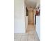 Hallway with tile floors and wall art leading to different areas of the home at 2321 Canal Dr # F25, Bradenton, FL 34207