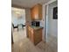 Galley kitchen features wooden cabinets, laminate countertops and stainless microwave at 2321 Canal Dr # F25, Bradenton, FL 34207