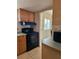 Galley kitchen features wood cabinets, laminate countertops and black range at 2321 Canal Dr # F25, Bradenton, FL 34207