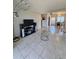 Spacious living room featuring tile flooring, modern lighting, and entertainment center at 2321 Canal Dr # F25, Bradenton, FL 34207
