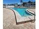 Relaxing community pool and jacuzzi featuring lounge seating and accessible entry steps for residents' enjoyment at 2321 Canal Dr # F25, Bradenton, FL 34207