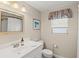 Well-lit bathroom with a sink vanity, mirror, and modern fixtures at 2435 Terry Ln, Sarasota, FL 34231