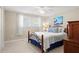 Inviting bedroom with a metal bed frame, a window, and warm decor at 2435 Terry Ln, Sarasota, FL 34231