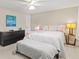 Relaxing bedroom featuring a queen bed, modern black dresser, and accent decor at 2435 Terry Ln, Sarasota, FL 34231