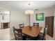 Dining room featuring a stylish light fixture and a view into the adjacent kitchen area at 2435 Terry Ln, Sarasota, FL 34231