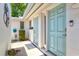 Charming courtyard entrance with dual front doors, freshly painted, and decorative potted plants at 2435 Terry Ln, Sarasota, FL 34231