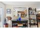 Inviting entryway with peek-through to kitchen, decorative elements, and unique storage solutions at 2435 Terry Ln, Sarasota, FL 34231