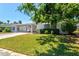Charming single-story home with a well-manicured lawn and a covered carport for convenient parking at 2435 Terry Ln, Sarasota, FL 34231