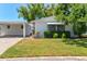 Charming single-story home with a well-manicured lawn and covered carport, offering curb appeal at 2435 Terry Ln, Sarasota, FL 34231