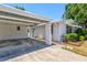 Quaint single-story home boasts a covered carport, freshly painted exterior and manicured landscaping at 2435 Terry Ln, Sarasota, FL 34231