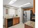 Bright kitchen features stainless steel refrigerator, tile backsplash, and granite countertops at 2435 Terry Ln, Sarasota, FL 34231
