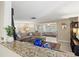 Open concept living area with plush seating, seamless transition to adjacent rooms, and granite countertops at 2435 Terry Ln, Sarasota, FL 34231