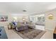 Spacious living room showcasing tile flooring, neutral tones, and seamless transition to the adjacent living area at 2435 Terry Ln, Sarasota, FL 34231