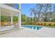 Beautiful backyard with a pool, patio seating, lush landscaping, and a privacy fence at 2554 Arlington St, Sarasota, FL 34239