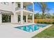 Modern home featuring outdoor living space with pool, patio, balcony, and manicured lawn at 2554 Arlington St, Sarasota, FL 34239