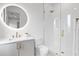 Modern bathroom with a glass-enclosed shower, stylish vanity, and a large, illuminated mirror at 2554 Arlington St, Sarasota, FL 34239