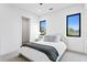 Bright bedroom featuring neutral tones, plush bedding, and modern windows offering natural light at 2554 Arlington St, Sarasota, FL 34239