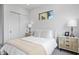 Inviting bedroom with neutral decor, sliding closet doors, and sleek bedside tables with lamps at 2554 Arlington St, Sarasota, FL 34239