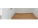 Walk-in closet featuring wood flooring and white baseboards, ready for organized storage at 2554 Arlington St, Sarasota, FL 34239