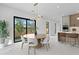 Bright dining room with modern light fixture, adjacent to kitchen and breakfast bar at 2554 Arlington St, Sarasota, FL 34239