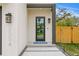 Modern home's black-framed glass front door, contemporary sconces, and house number give a sophisticated curb appeal at 2554 Arlington St, Sarasota, FL 34239