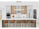 Modern kitchen with bar seating, stainless steel appliances, and designer lighting at 2554 Arlington St, Sarasota, FL 34239