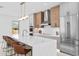 Modern kitchen with seating at island with stone counter tops and stainless appliances at 2554 Arlington St, Sarasota, FL 34239