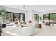 Open concept living room and dining area with backyard view and access to patio and pool at 2554 Arlington St, Sarasota, FL 34239
