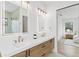 Elegant main bathroom with double sinks, modern lighting, and view to the bedroom at 2554 Arlington St, Sarasota, FL 34239
