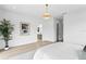 Spacious main bedroom with chandelier, hardwood floors, and view to the main bath at 2554 Arlington St, Sarasota, FL 34239