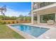 A modern pool is attached to a two-story home, offering a luxurious outdoor space at 2554 Arlington St, Sarasota, FL 34239