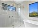 Luxurious shower with glass enclosure and a standalone tub with modern fixtures at 2554 Arlington St, Sarasota, FL 34239
