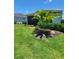 Home's manicured lawn showcases tropical landscaping and a screened in patio for relaxation at 26017 Seastone Dr, Englewood, FL 34223