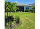 Well-maintained backyard featuring a screened patio and lush landscaping, creating a private oasis at 26017 Seastone Dr, Englewood, FL 34223
