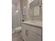 Bathroom featuring a tiled shower and vanity with a stone countertop and modern faucet at 26017 Seastone Dr, Englewood, FL 34223